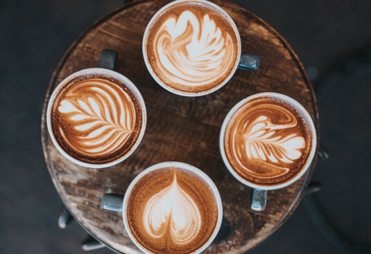 4 cups of coffee with different designs